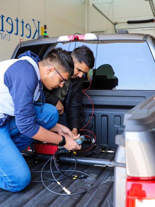 Graduate students brake testing vehicle